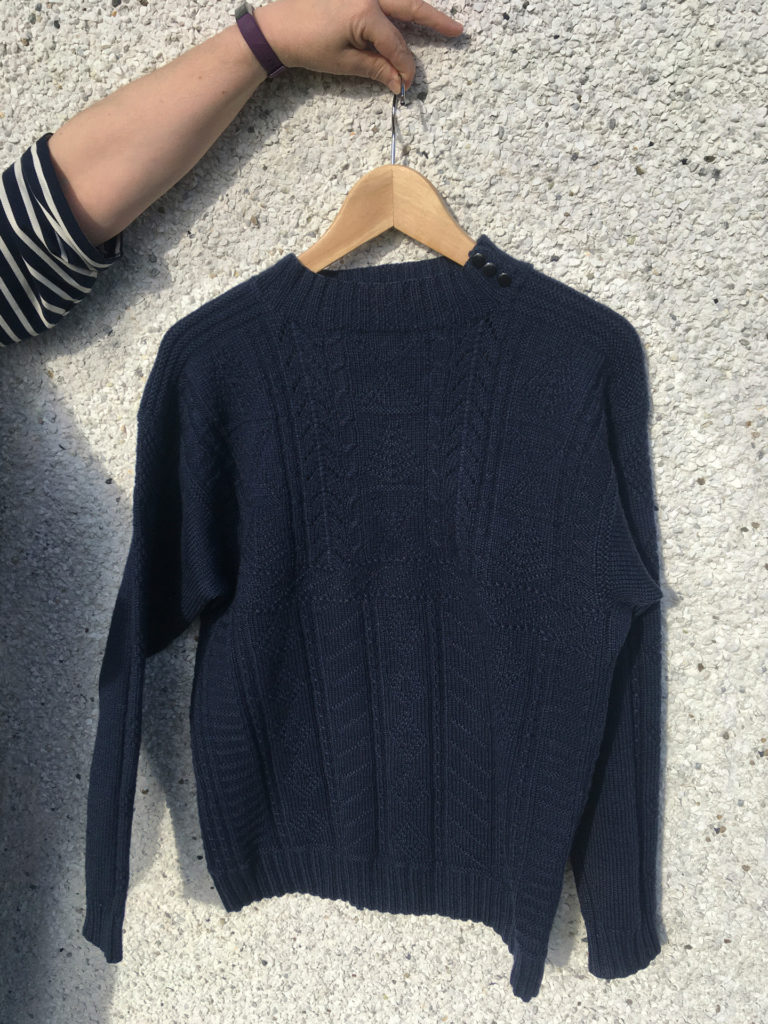 women holding blue eriskay jumper on hanger outer hebrides