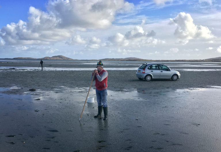 person cockling on beach traigh mhor isle of barra outer hebrides